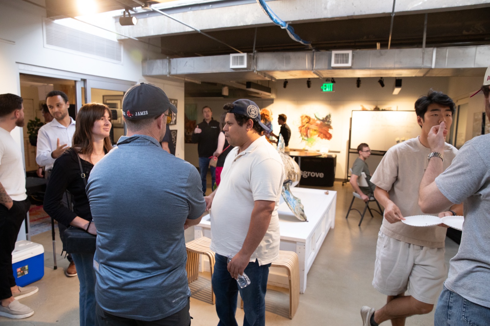 A full room of attendees talking at Mangrove Monday