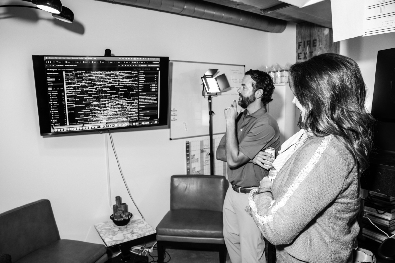 Attendees watching a strategy demo on a wall screen