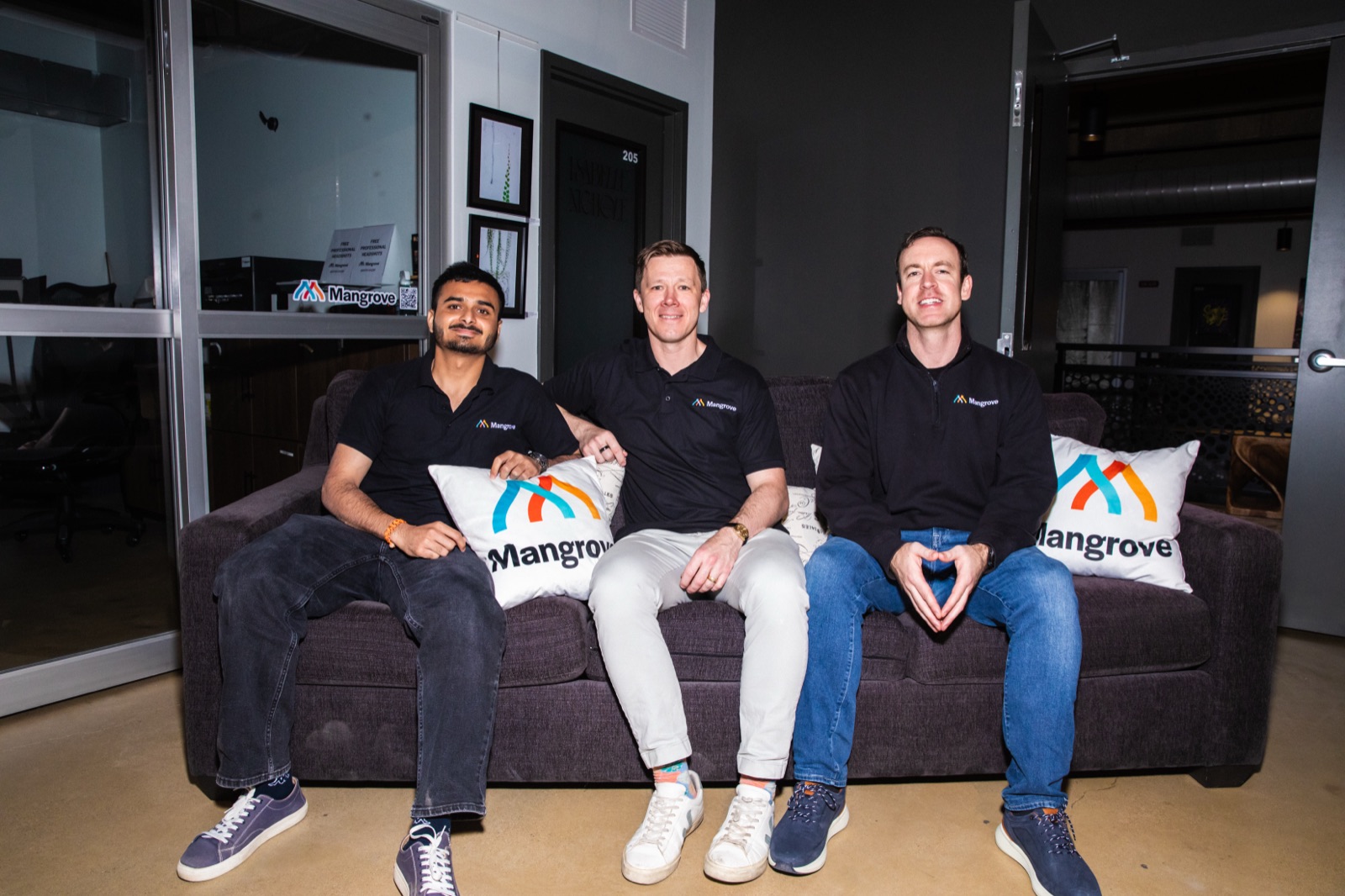 The Mangrove team on a couch with Mangrove pillows